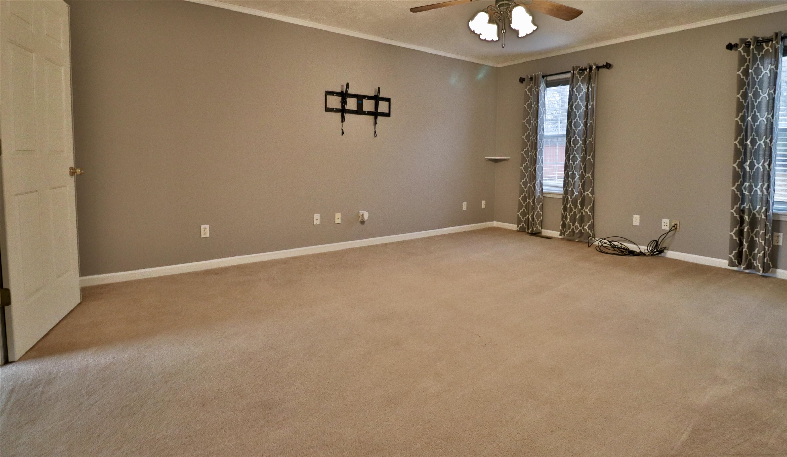 302 Ford Store Road Ripley, TN 38063 - Photo 14 of 40 an empty room with a ceiling fan and window