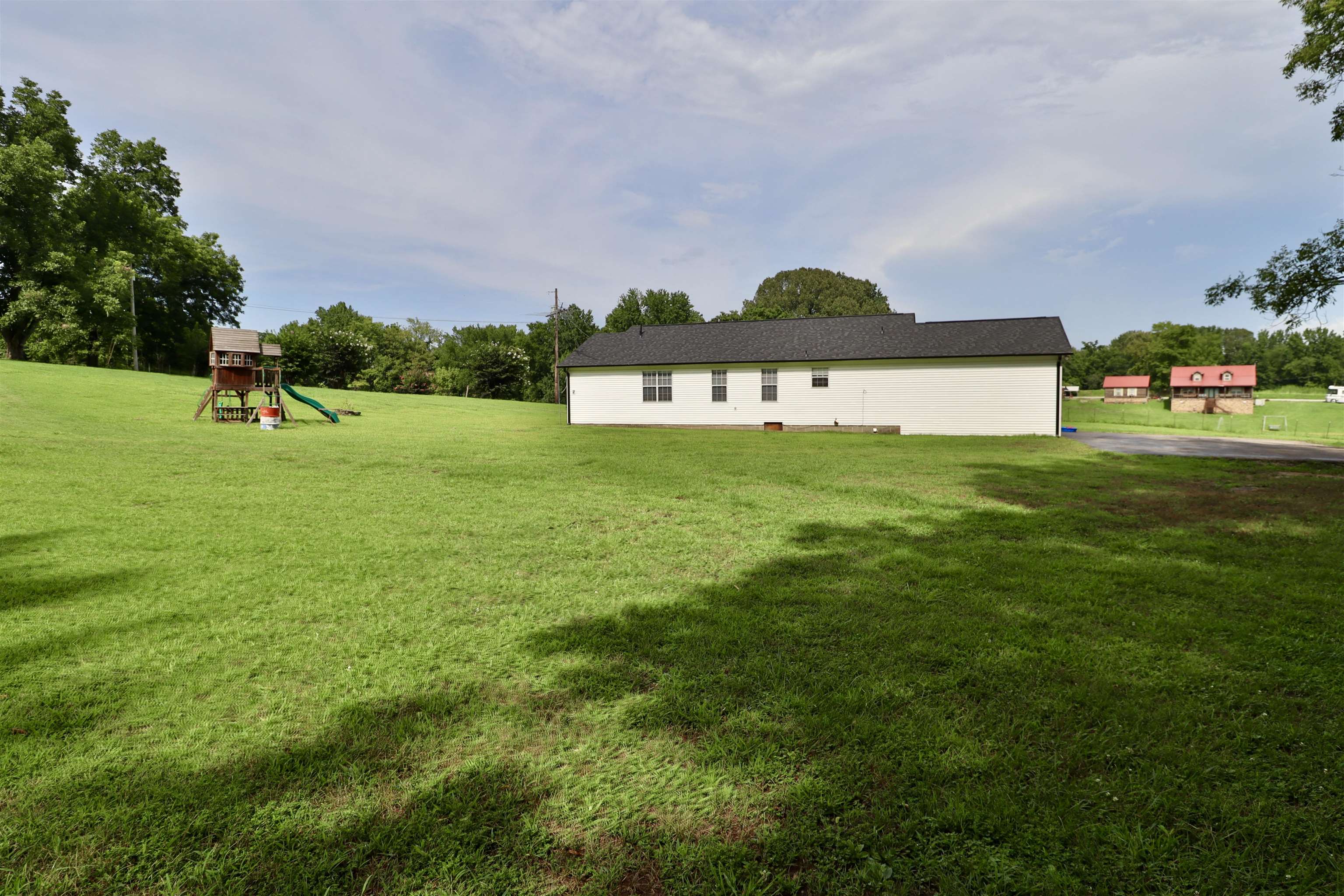 302 Ford Store Road Ripley, TN 38063 - Photo 36 of 40 a front view of a house with a yard and garage