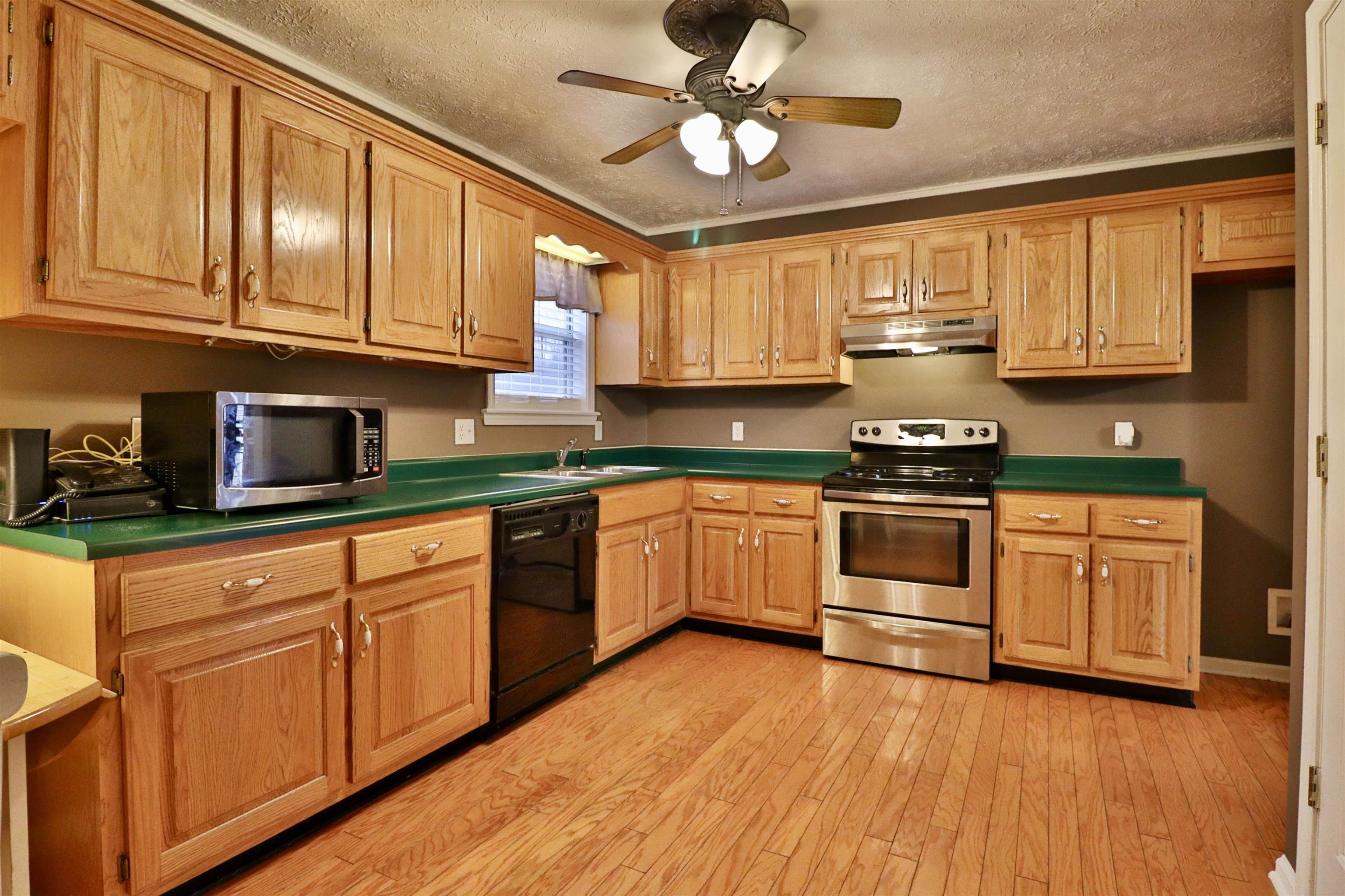 302 Ford Store Road Ripley, TN 38063 - Photo 7 of 40 a kitchen with stainless steel appliances granite countertop a stove sink and cabinets