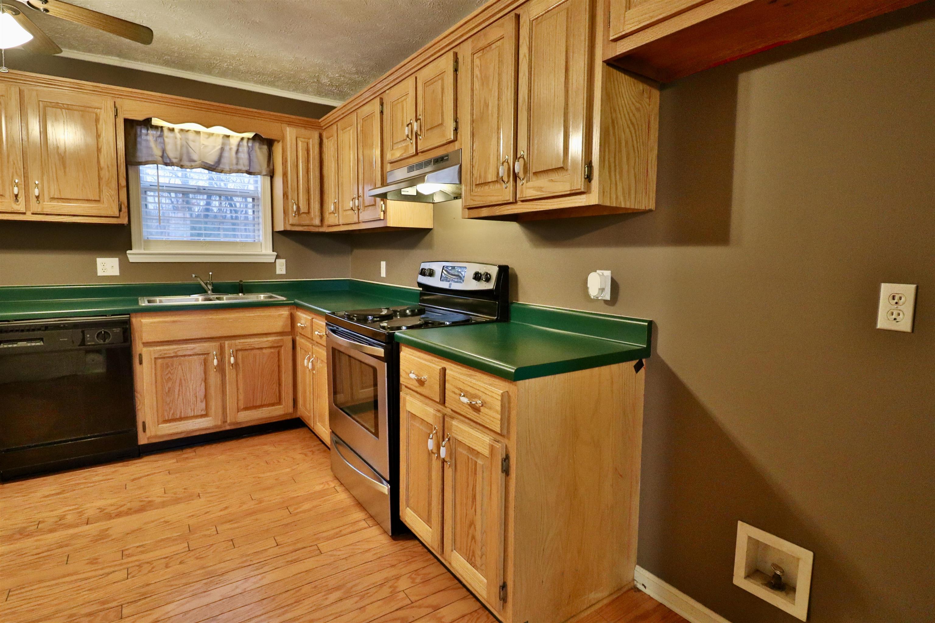 302 Ford Store Road Ripley, TN 38063 - Photo 8 of 40 a kitchen with stainless steel appliances granite countertop a stove a sink and a microwave