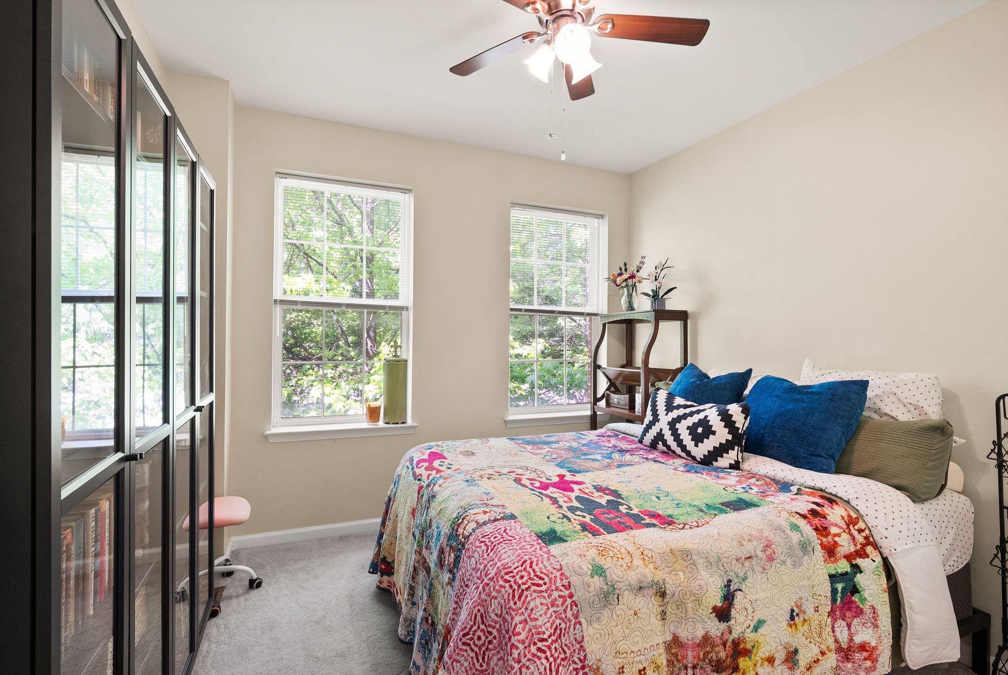 12414 A Liberty Bridge Road Fairfax, VA 22033 - Photo 25 of 38 a bedroom with a bed and a chandelier