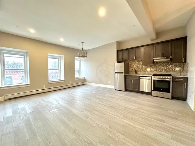 a view of a kitchen with a stove cabinets and wooden floor