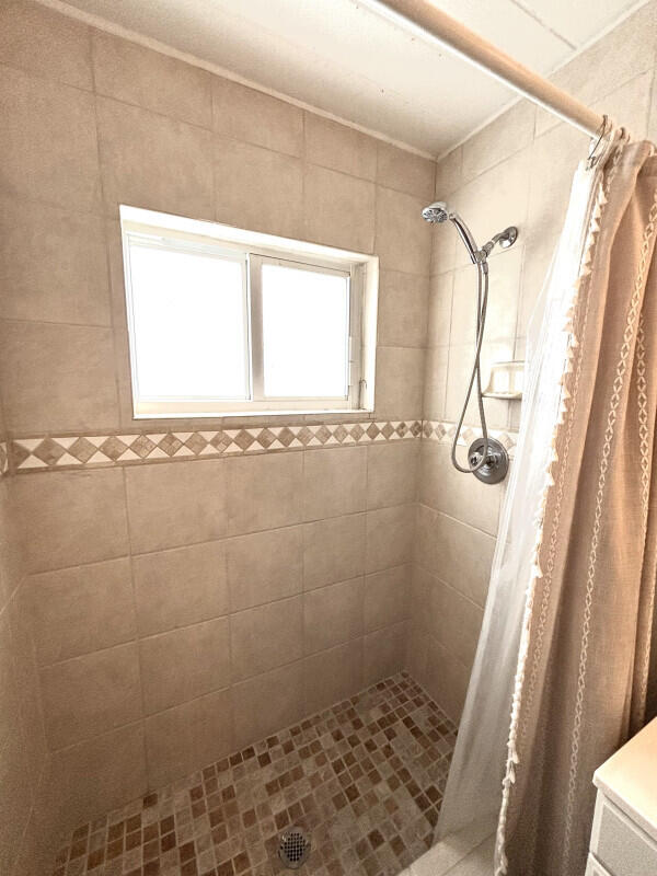 124 South Hammock Road Islamorada, FL 33036 - Photo 6 of 11 a bathroom with a window a shower and yard