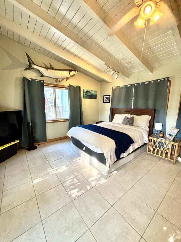 124 South Hammock Road Islamorada, FL 33036 - Photo 7 of 11 a bedroom with a bed and a walk in closet