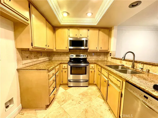 a kitchen with granite countertop a stove and a sink