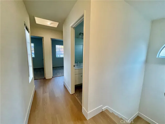a view of a hallway with wooden floor