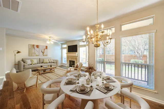 a view of a dining room with furniture wooden floor and chandelier