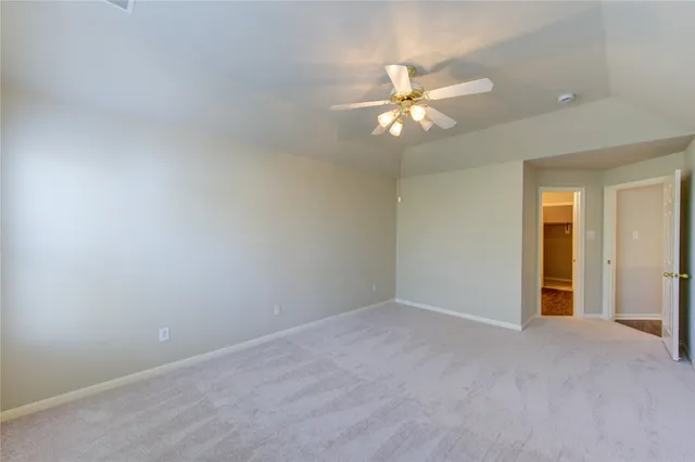 a view of an empty room with a fan