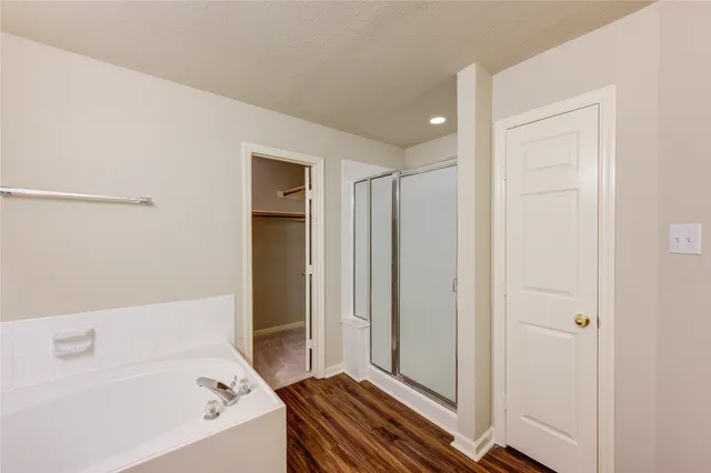 a bathroom with a bathtub and a shower