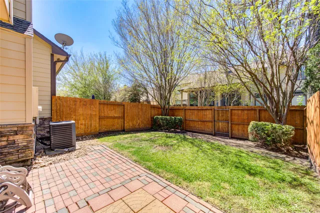a view of a backyard with wooden fence