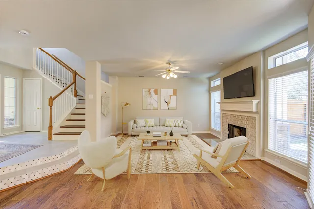 a living room with furniture fireplace and wooden floor