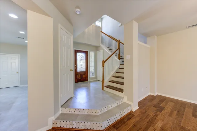 a view of entryway and hall with wooden floor