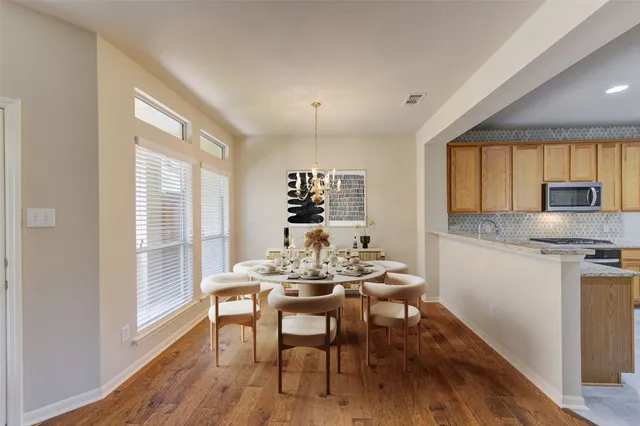 a kitchen with a table and chairs in it
