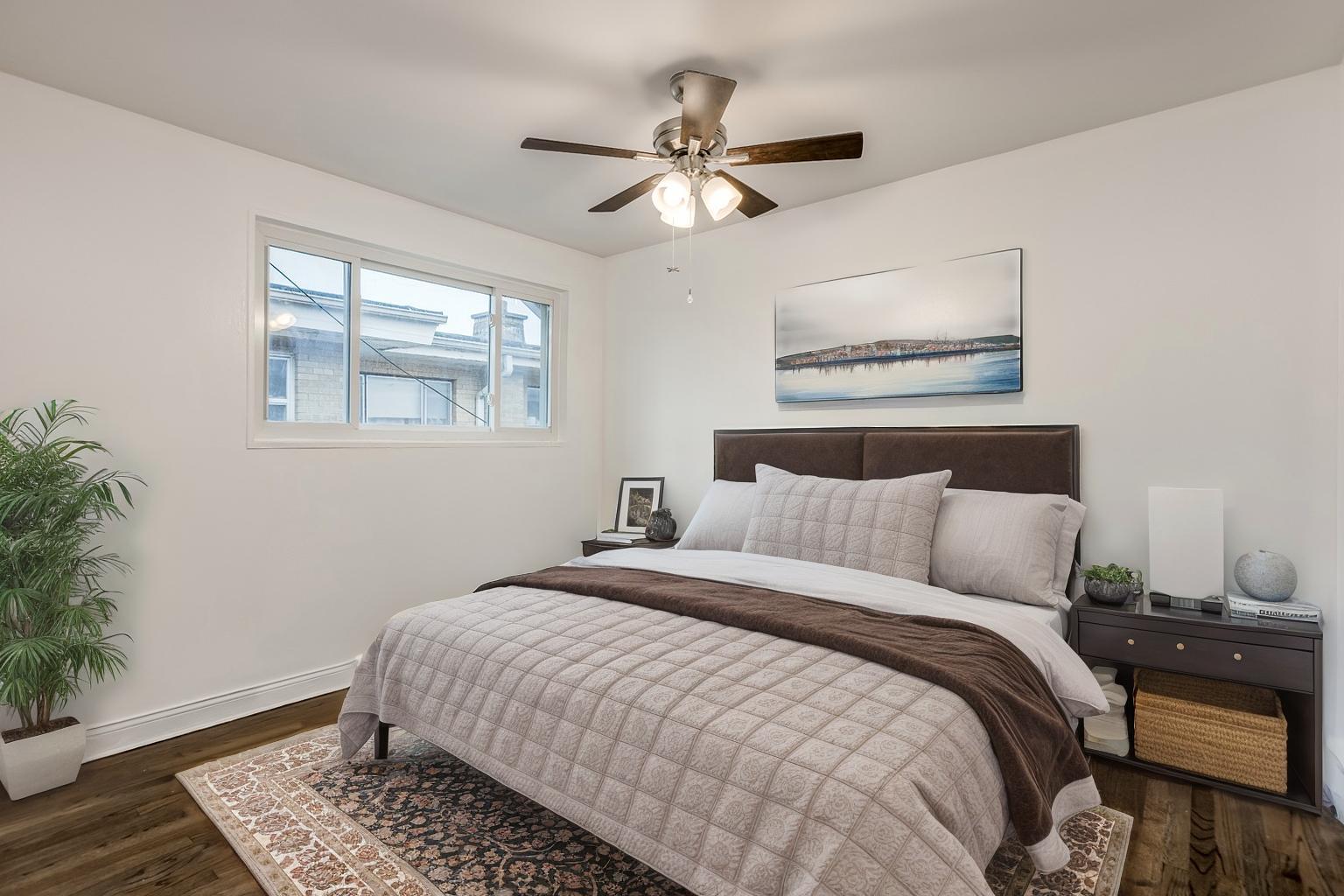 5107 North Springfield Avenue, Unit B Chicago, IL 60625 - Photo 17 of 25 a bedroom with a bed and wooden floor