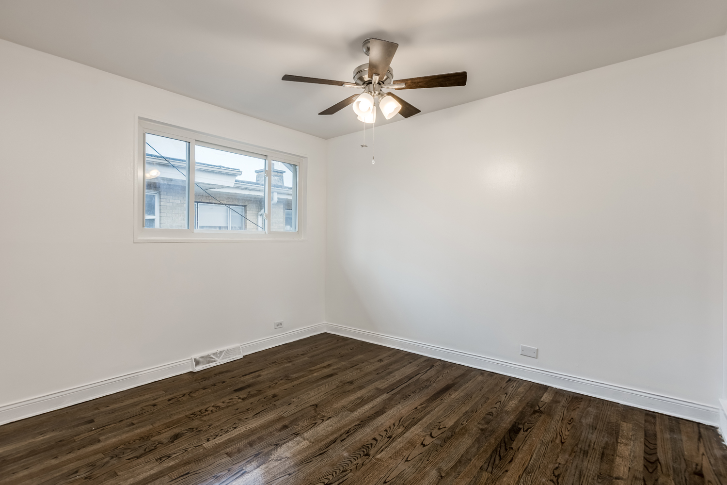 5107 North Springfield Avenue, Unit B Chicago, IL 60625 - Photo 18 of 25 a view of a room with wooden floor and a ceiling fan