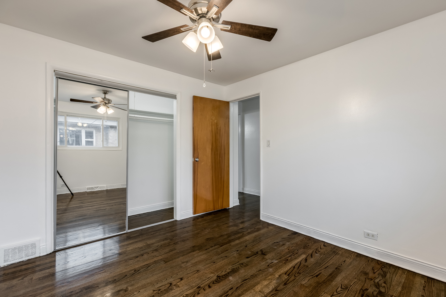 5107 North Springfield Avenue, Unit B Chicago, IL 60625 - Photo 19 of 25 wooden floor in an empty room with a window
