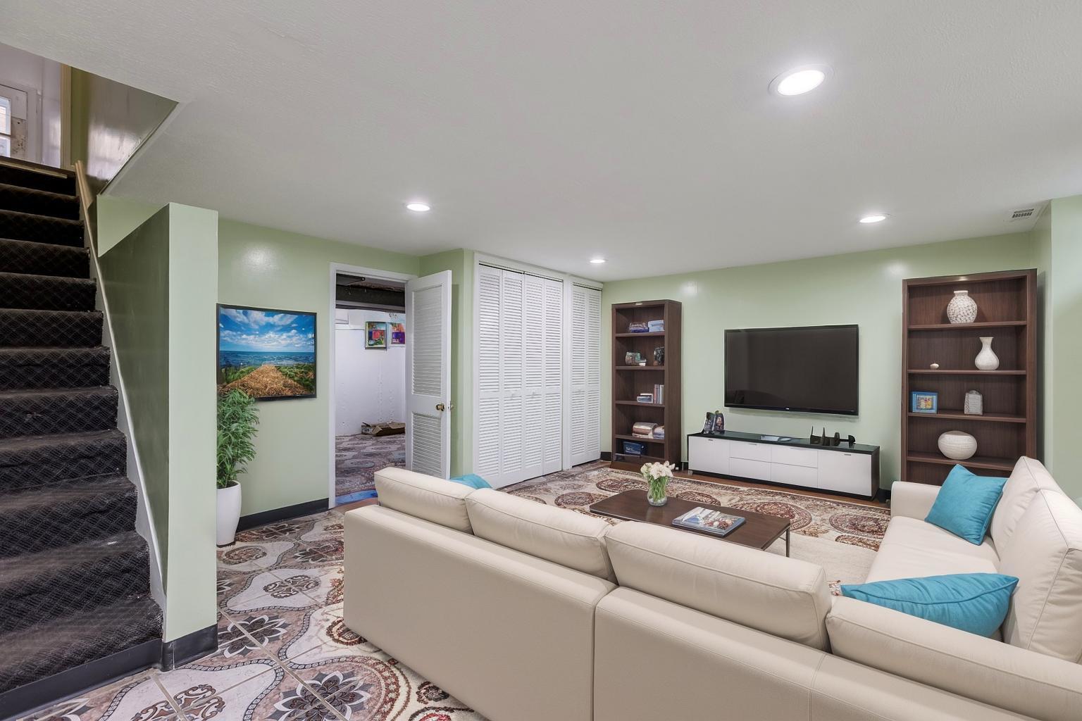 5107 North Springfield Avenue, Unit B Chicago, IL 60625 - Photo 21 of 25 a living room with furniture and a flat screen tv