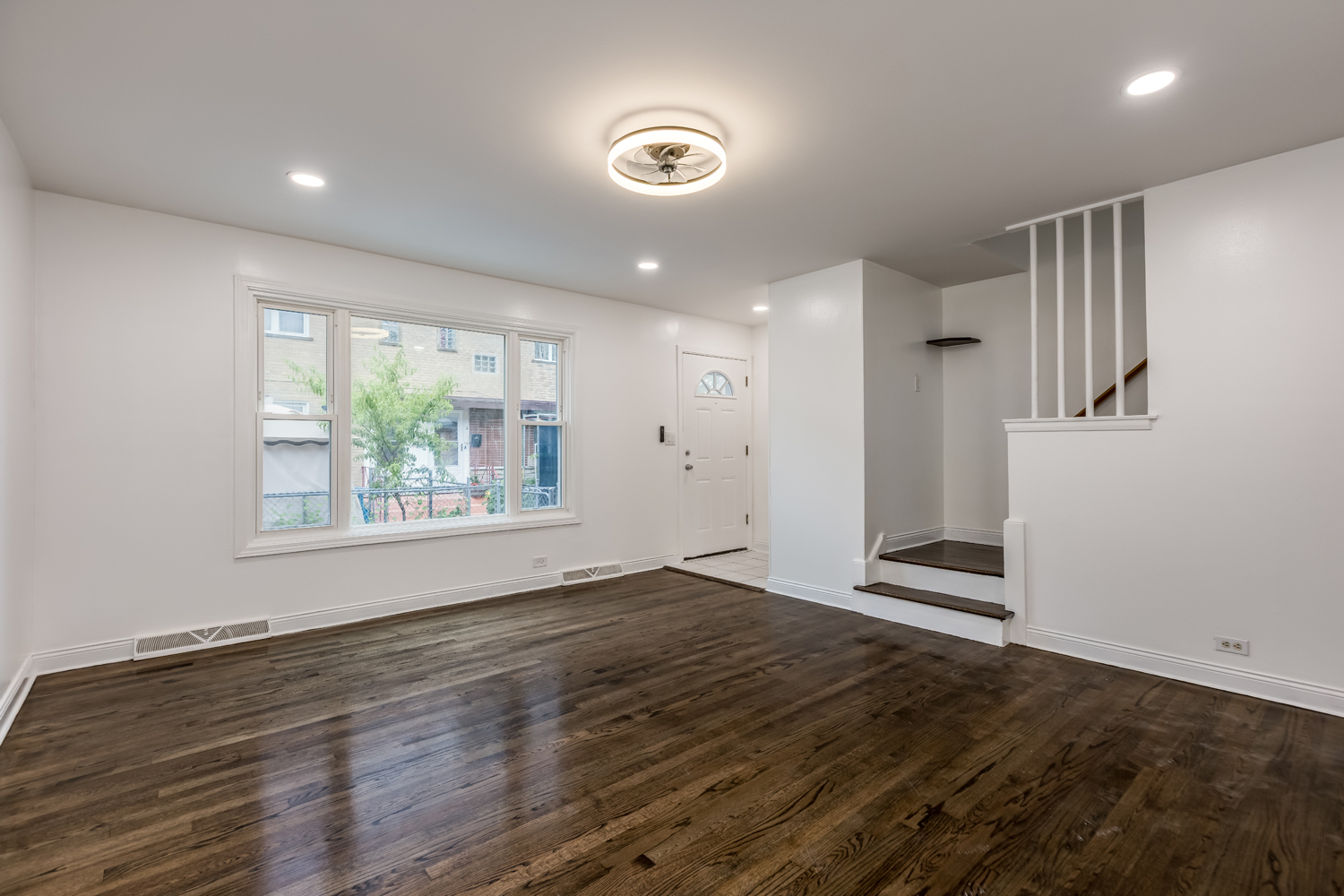 5107 North Springfield Avenue, Unit B Chicago, IL 60625 - Photo 4 of 25 an empty room with wooden floor and windows