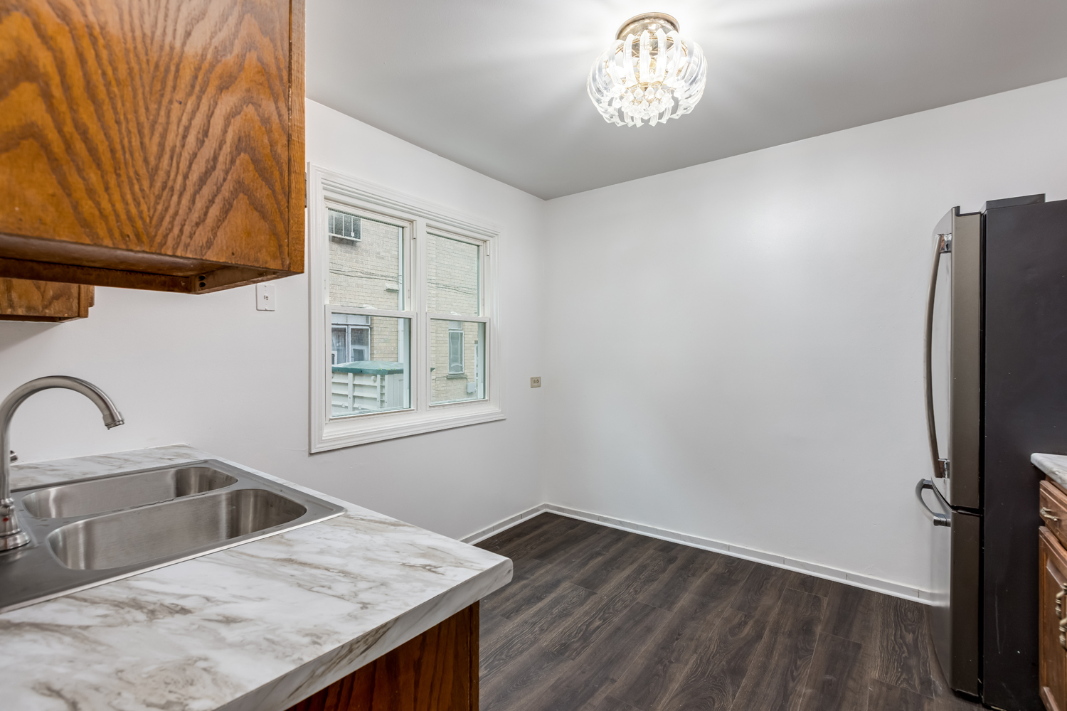 5107 North Springfield Avenue, Unit B Chicago, IL 60625 - Photo 9 of 25 a kitchen with a refrigerator and a sink