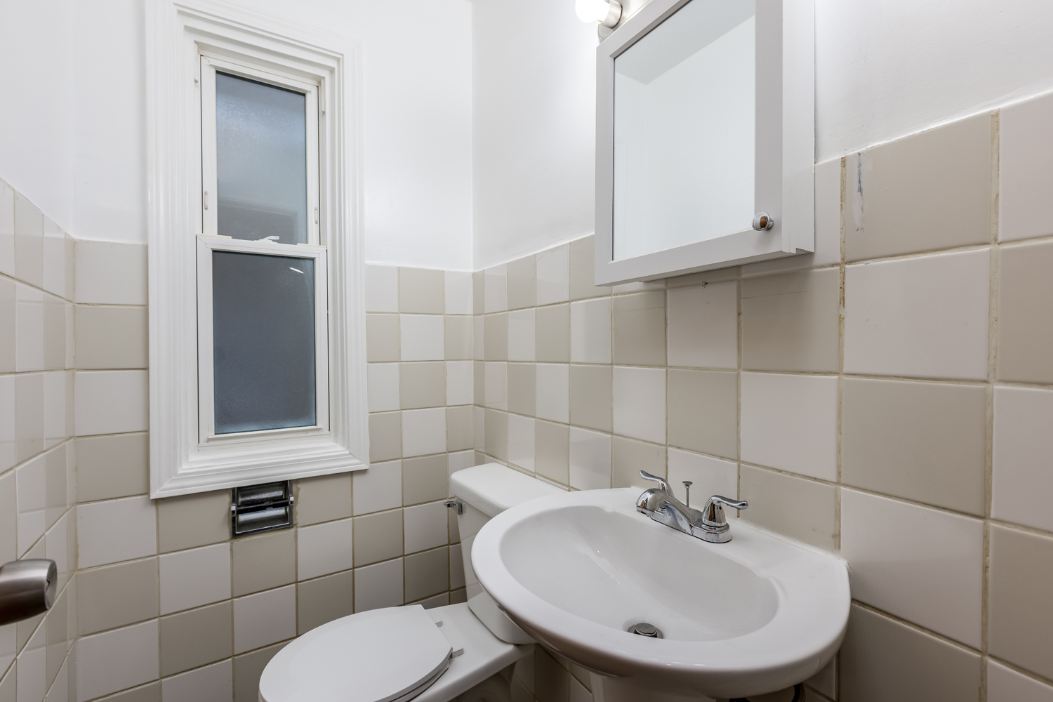 5107 North Springfield Avenue, Unit B Chicago, IL 60625 - Photo 10 of 25 a bathroom with a sink a toilet and mirror