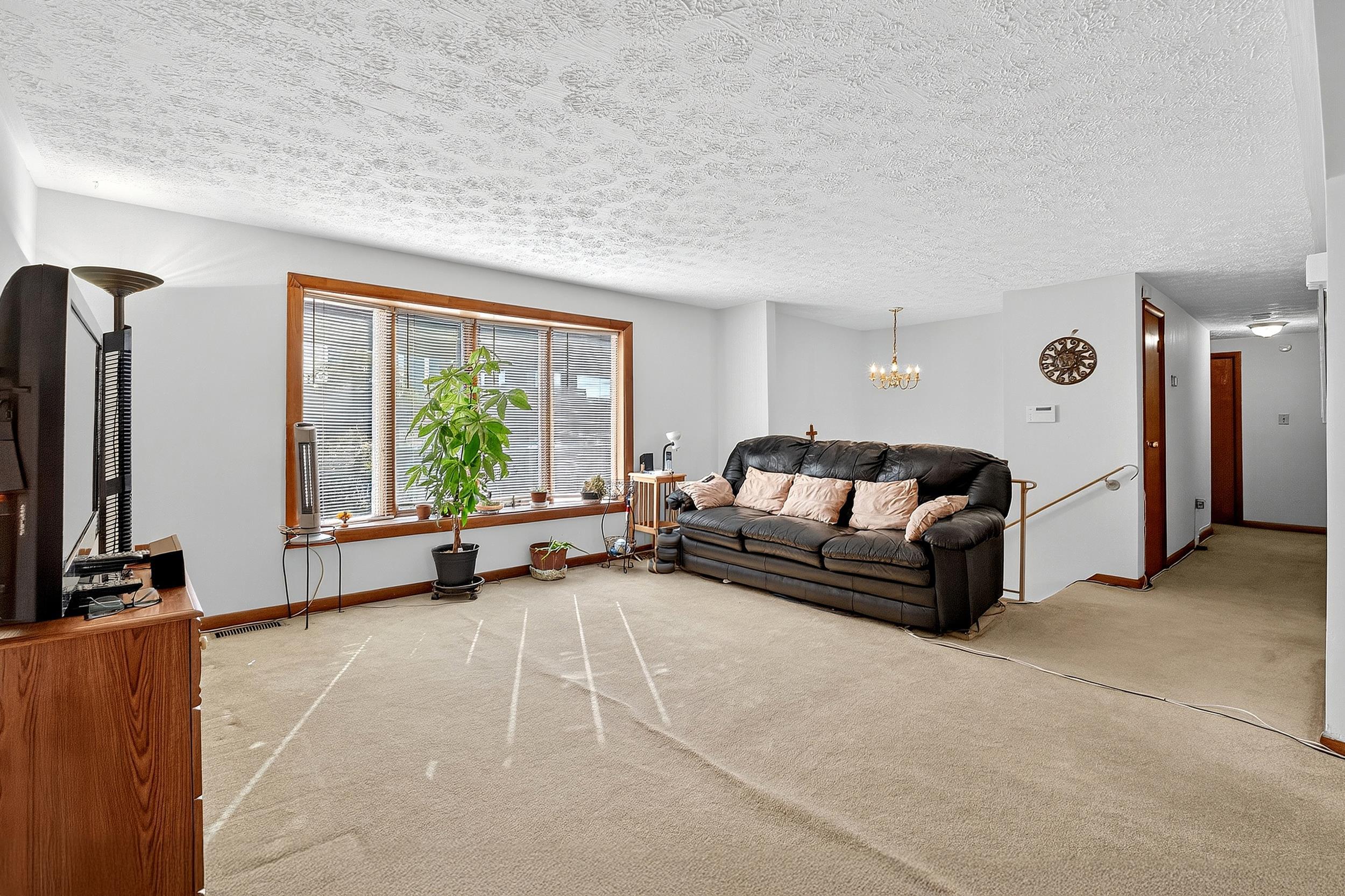 87 Merseles Street, Unit 2 Jersey City, NJ 07302 - Photo 5 of 16 a living room with furniture and a flat screen tv