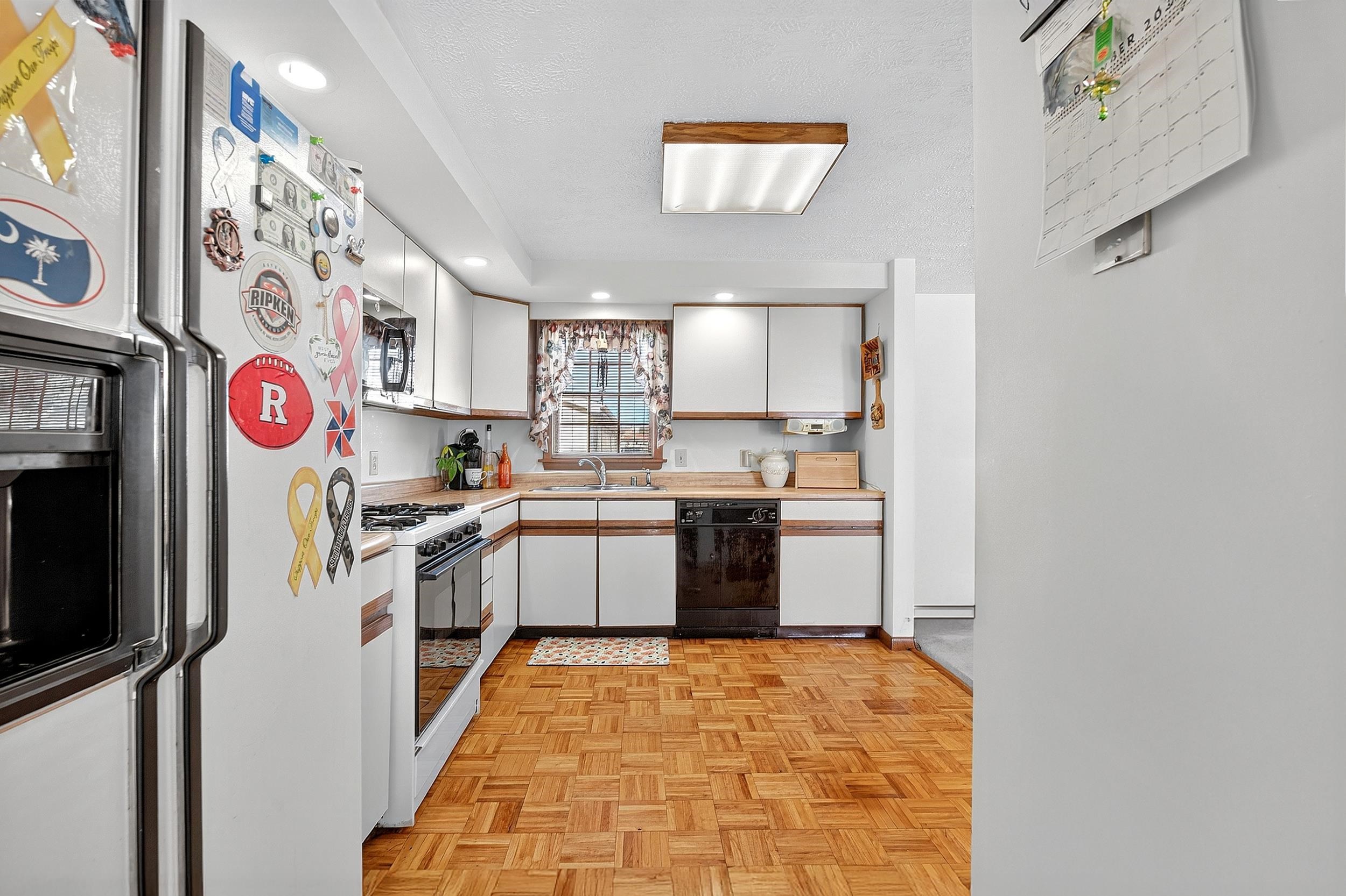 87 Merseles Street, Unit 2 Jersey City, NJ 07302 - Photo 9 of 16 a kitchen with a sink cabinets and window