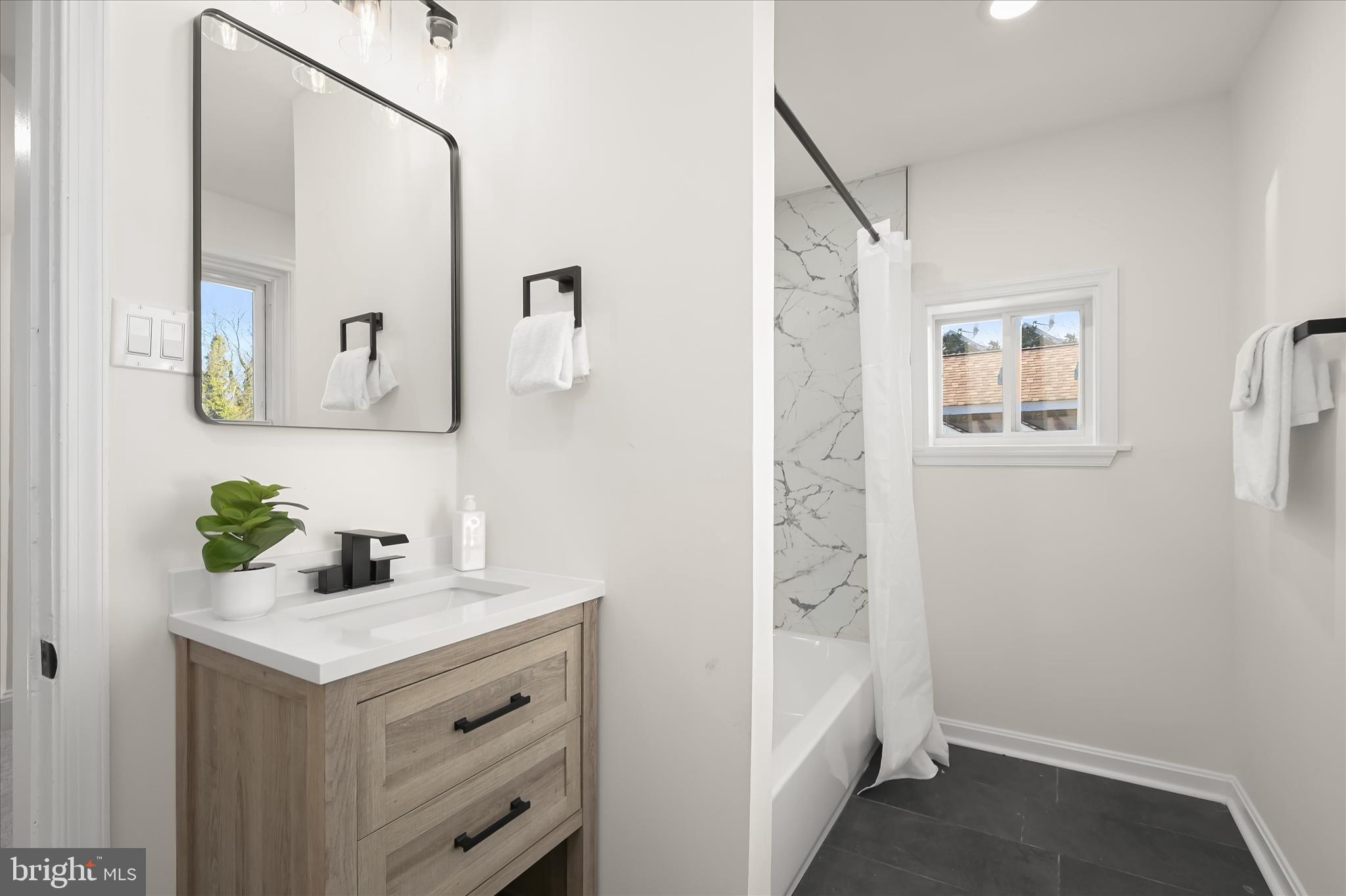 1236 Elm Ridge Avenue Baltimore, MD 21229 - Photo 20 of 41 a bathroom with a sink and a mirror