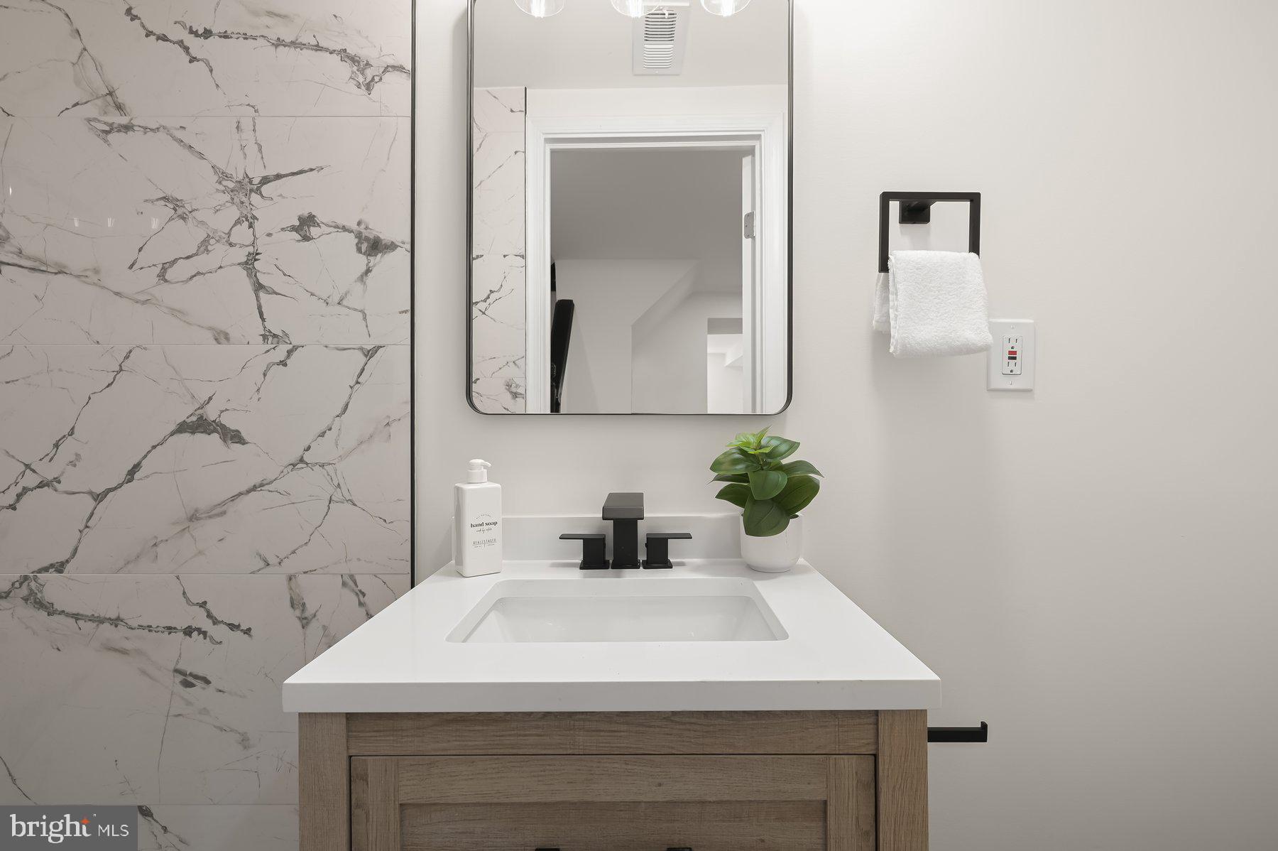 1236 Elm Ridge Avenue Baltimore, MD 21229 - Photo 30 of 41 a bathroom with a sink and a mirror