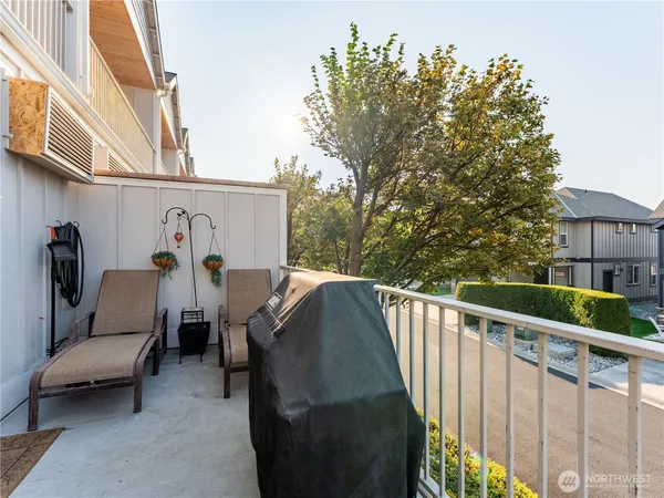 a view of city from balcony with furniture