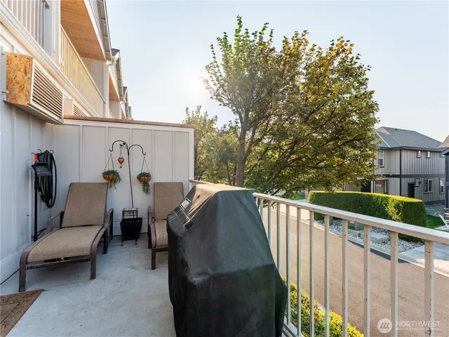 a view of city from balcony with furniture