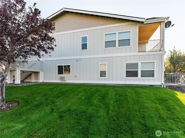 a swimming pool with barbeque oven outdoor seating