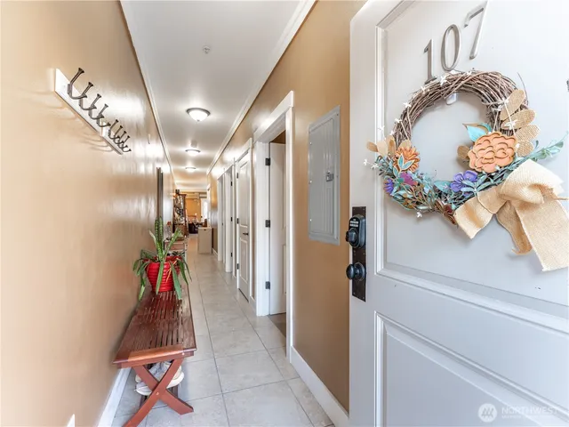 a view of a hallway and a livingroom with furniture