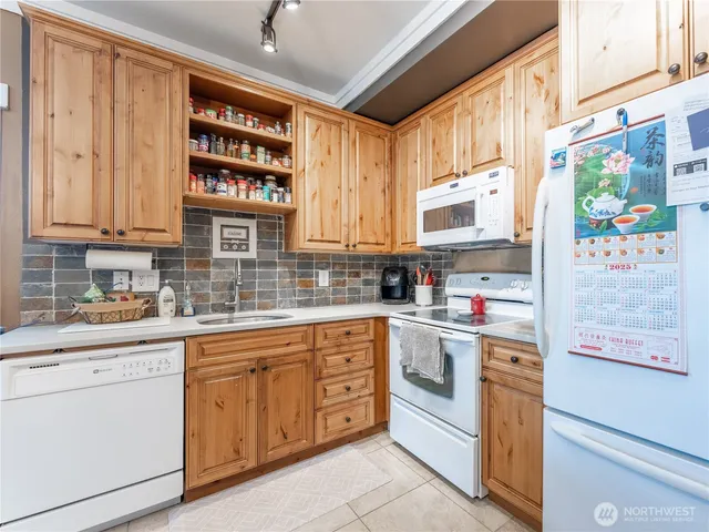 a kitchen with a refrigerator and a sink