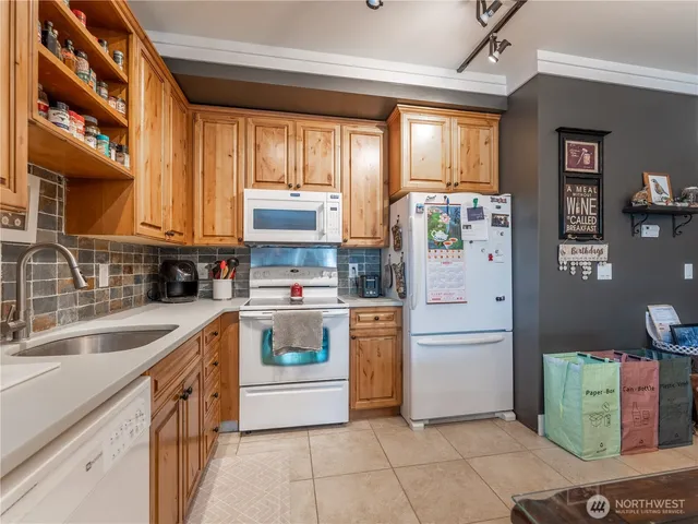 a bathroom with double vanity and a mirror
