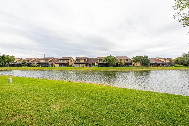 a view of a lake with houses in the back