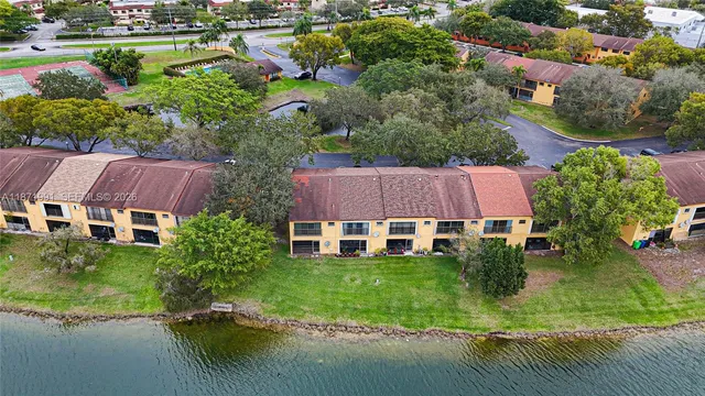 an aerial view of house with yard and lake view