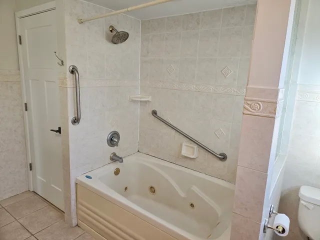 a bathroom with a tub and a shower