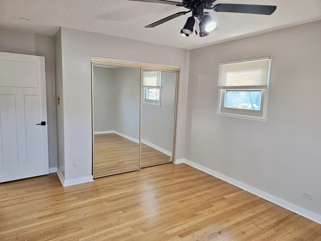 a view of an empty room with a ceiling fan