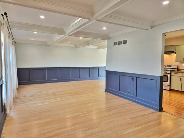 a view of a kitchen with wooden cabinet