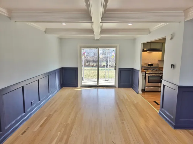 a view of a kitchen with wooden floor and electronic appliances