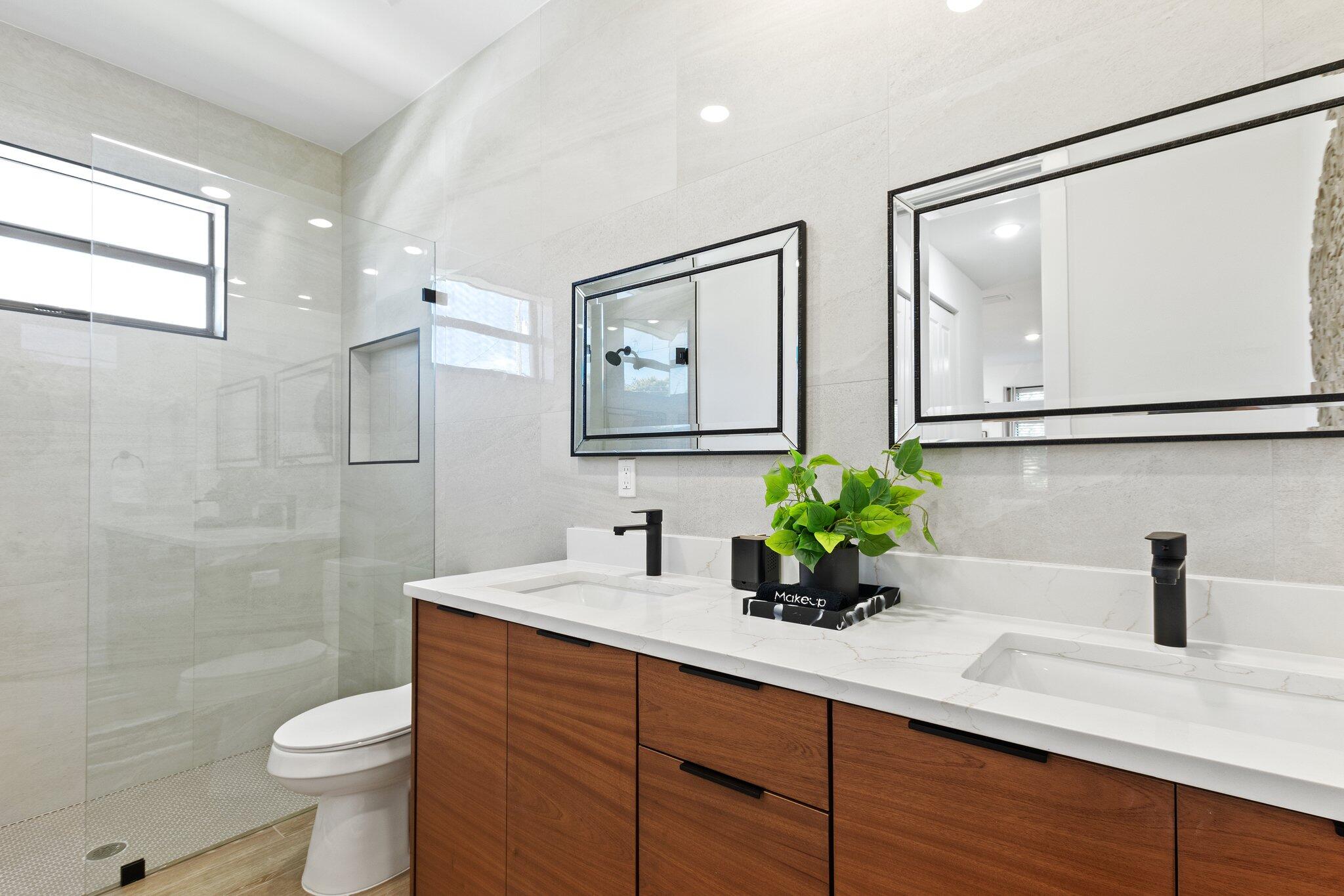 601 Southwest 3rd Street Delray Beach, FL 33444 - Photo 41 of 75 a bathroom with a double vanity sink toilet and a mirror