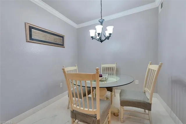 a view of a dining room with furniture and chandelier