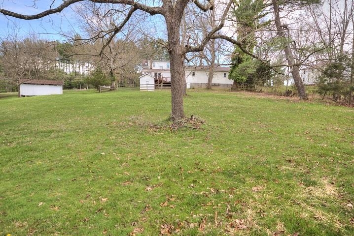 1310 New Hope Road Staunton, VA 24401 - Photo 40 of 62 a backyard of a house with lots of green space and fountain