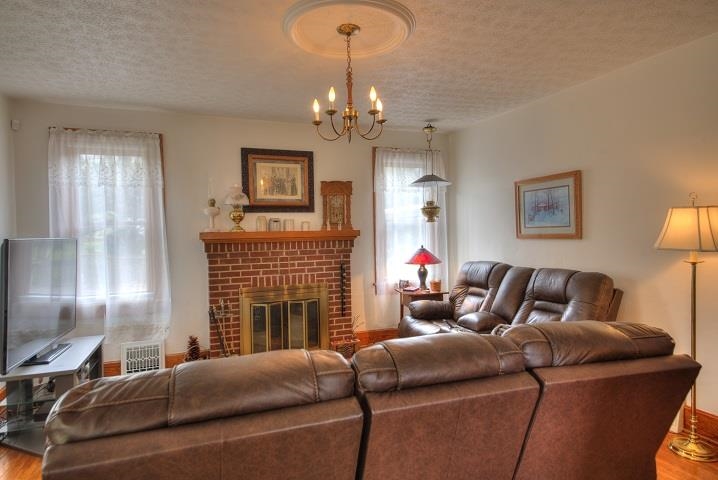 1310 New Hope Road Staunton, VA 24401 - Photo 42 of 62 a living room with furniture a fireplace and a chandelier