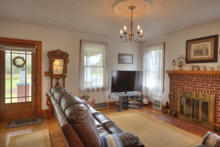 1310 New Hope Road Staunton, VA 24401 - Photo 6 of 62 a living room with furniture a fireplace and a flat screen tv
