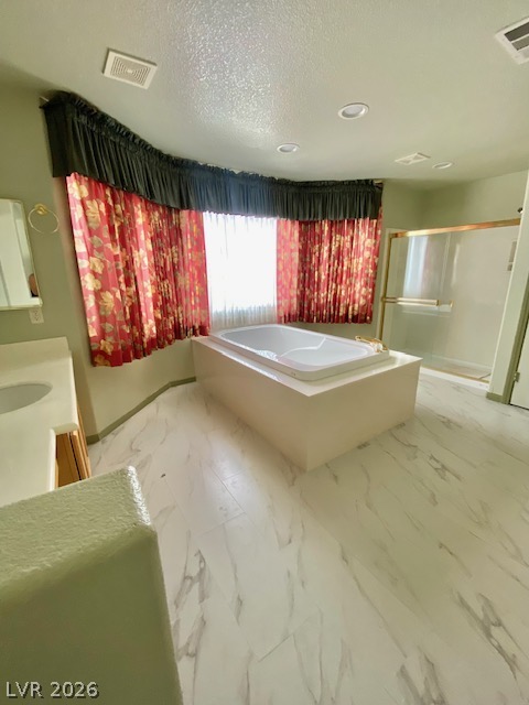 141 Rancho Maria Street Las Vegas, NV 89148 - Photo 18 of 30 Marble tile flooring and a central soaking tub define this spacious bathroom layout.