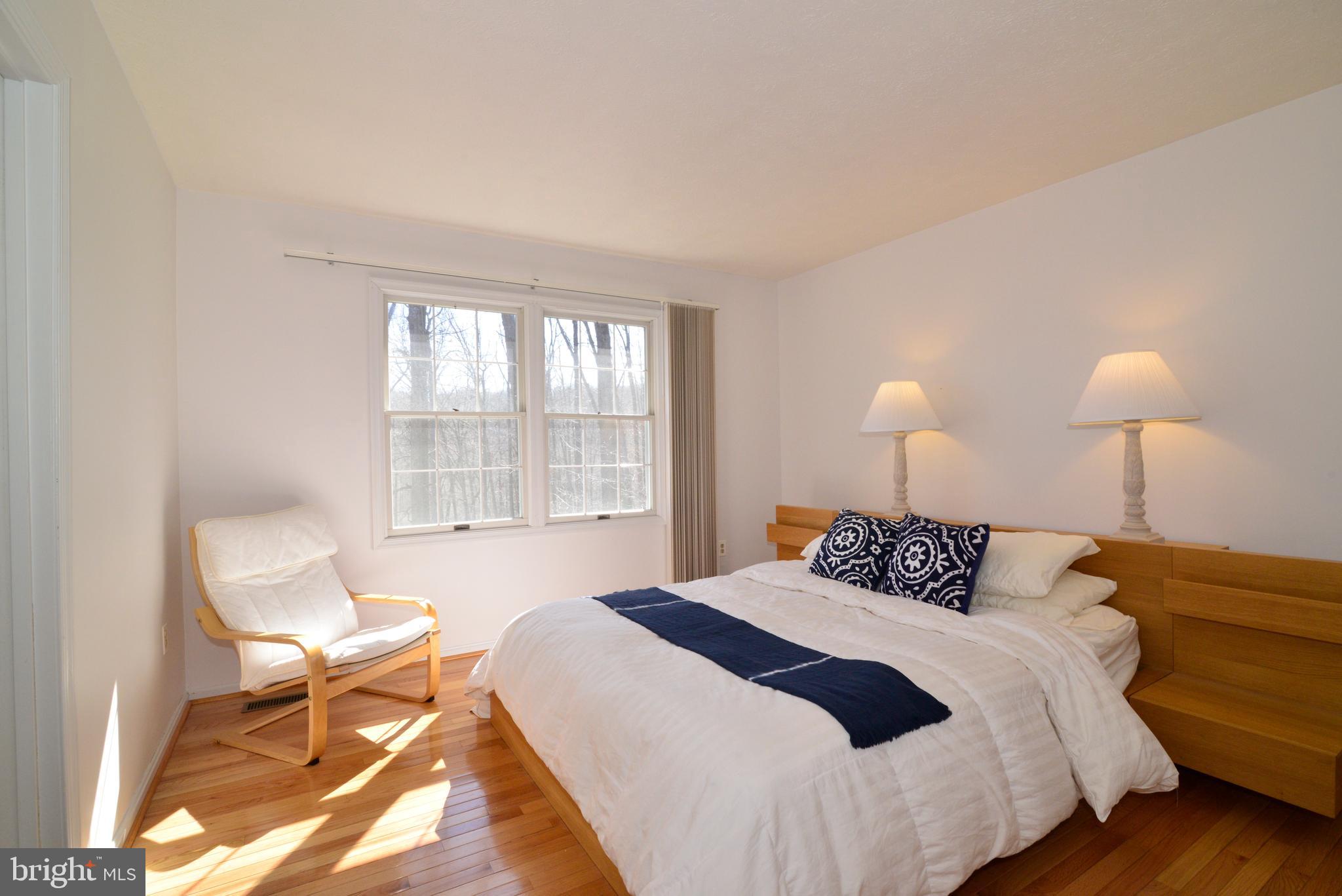 1966 Barton Hill Road Reston, VA 20191 - Photo 41 of 52 a bedroom with a bed and wooden floor