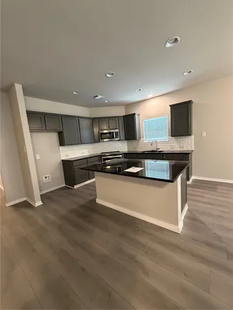 a kitchen with stainless steel appliances granite countertop a sink and stove top oven