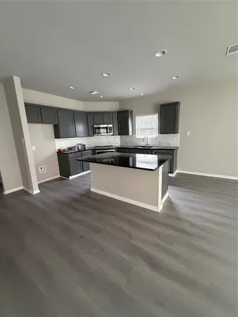 a view of kitchen with sink microwave and stove