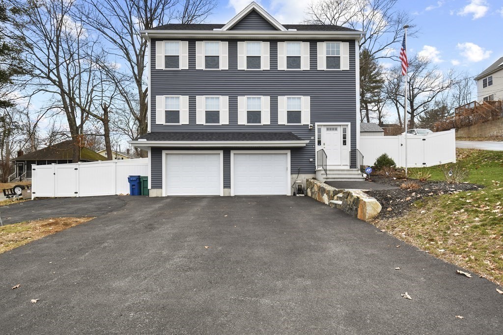 49 Lexington Road Billerica, MA 01821 - Photo 1 of 1 a front view of a house with a yard and garage